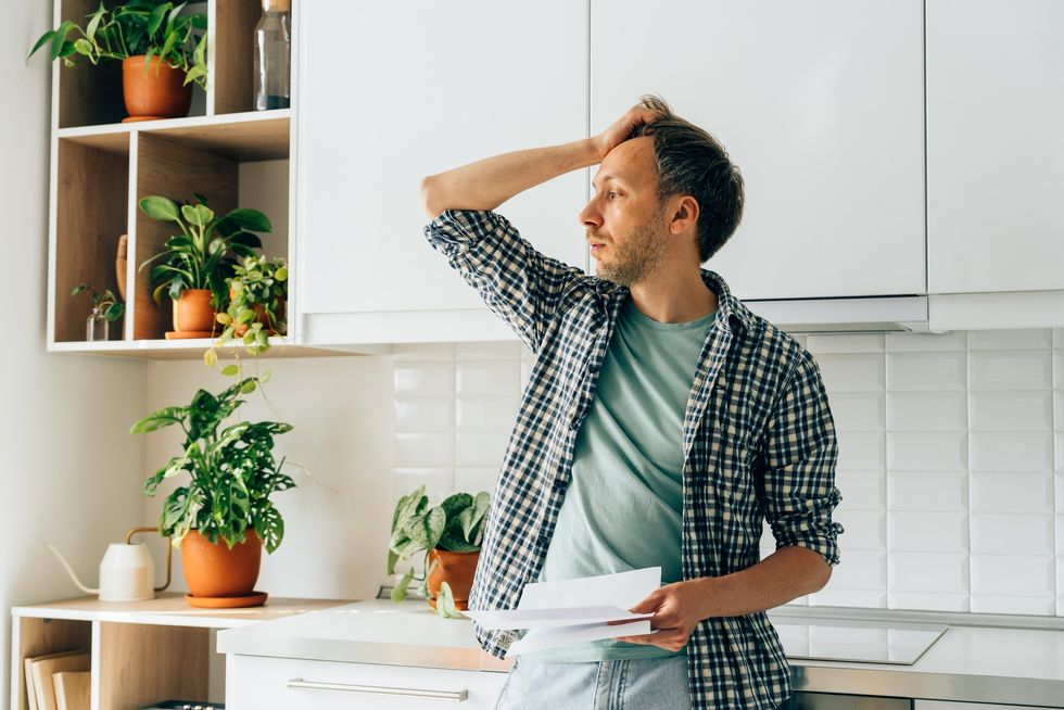 Man looking worried while holding a letter