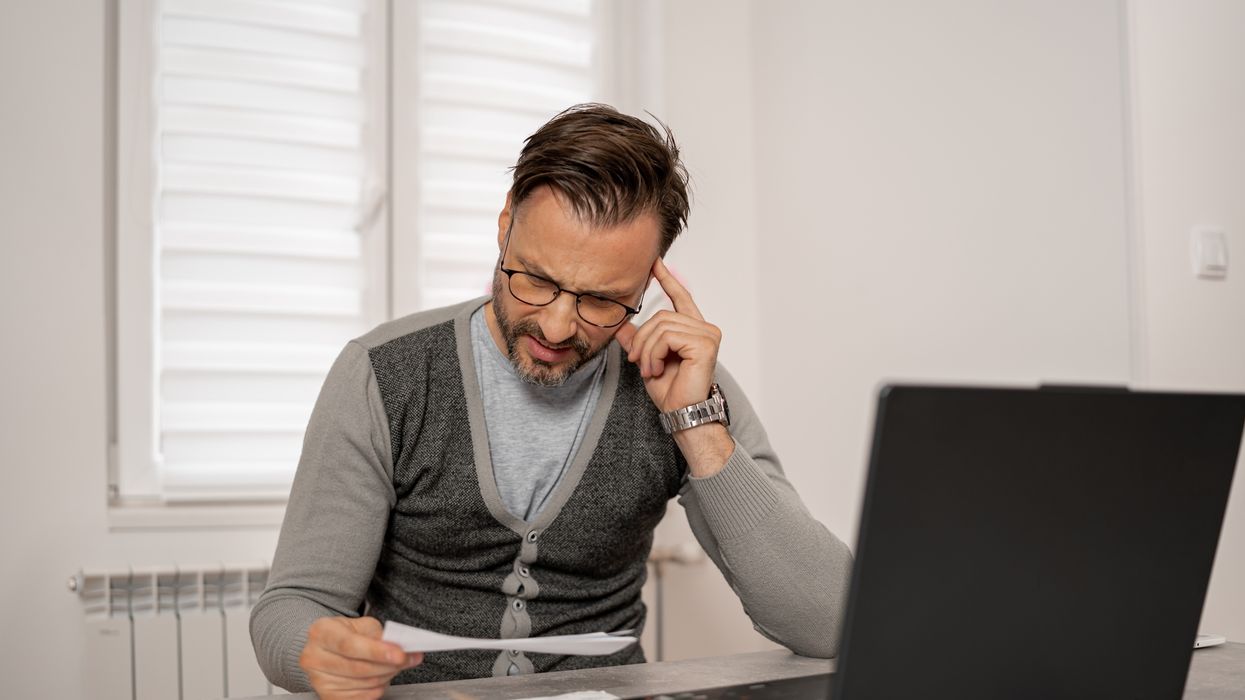 Man looks at financial statement