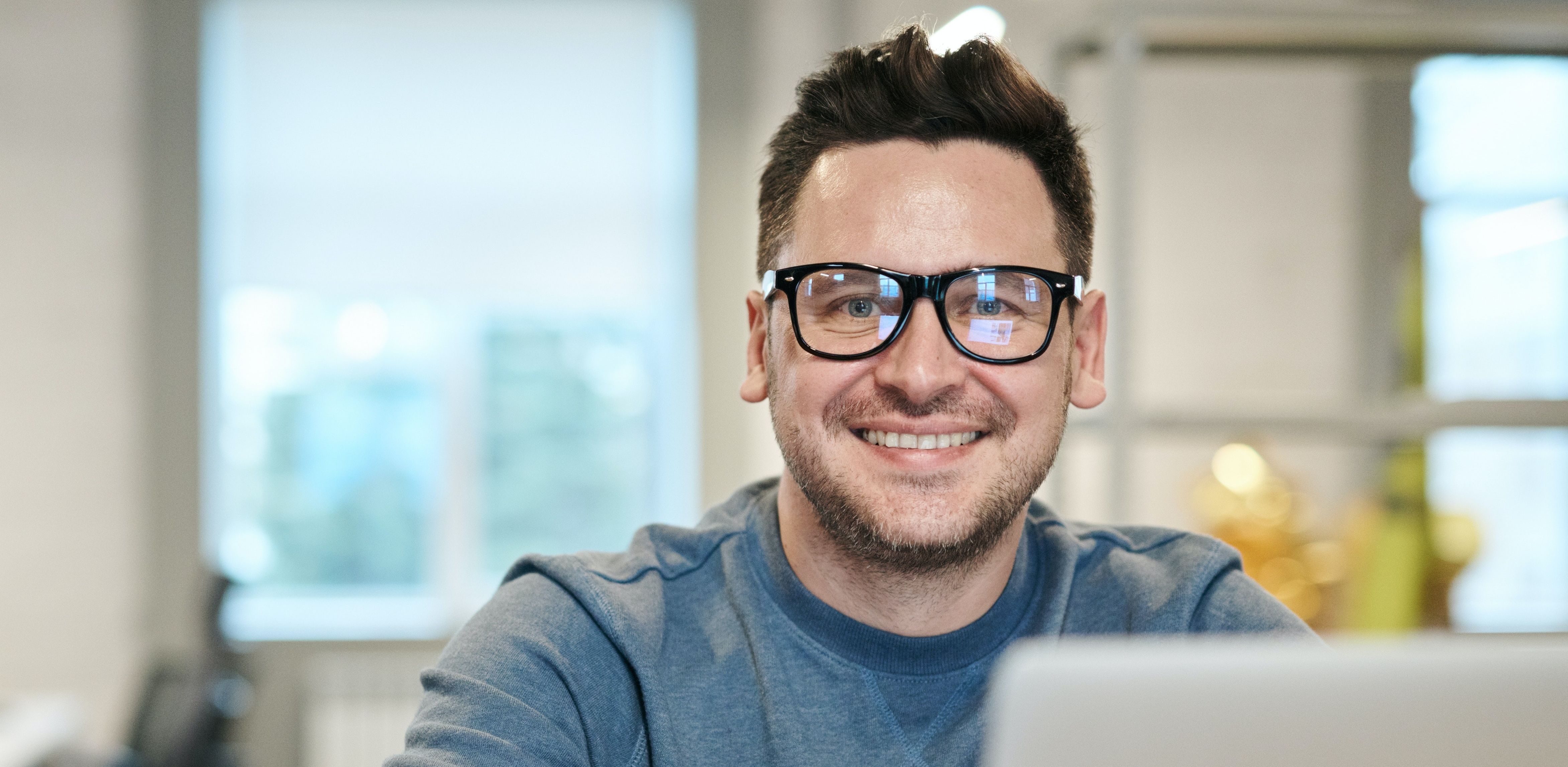 Man looks happy by laptop