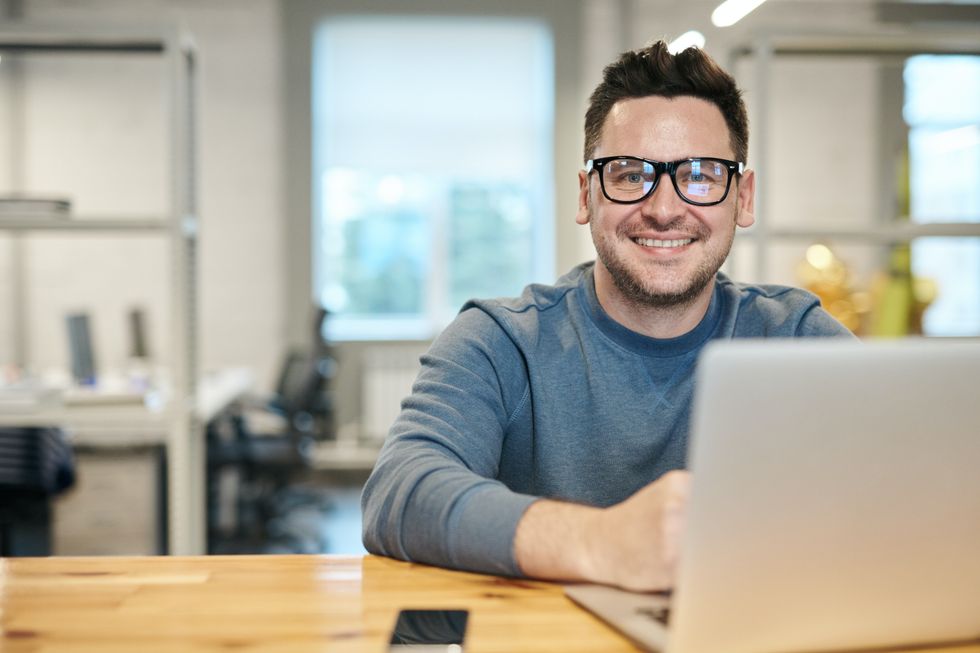 Man looks happy by laptop