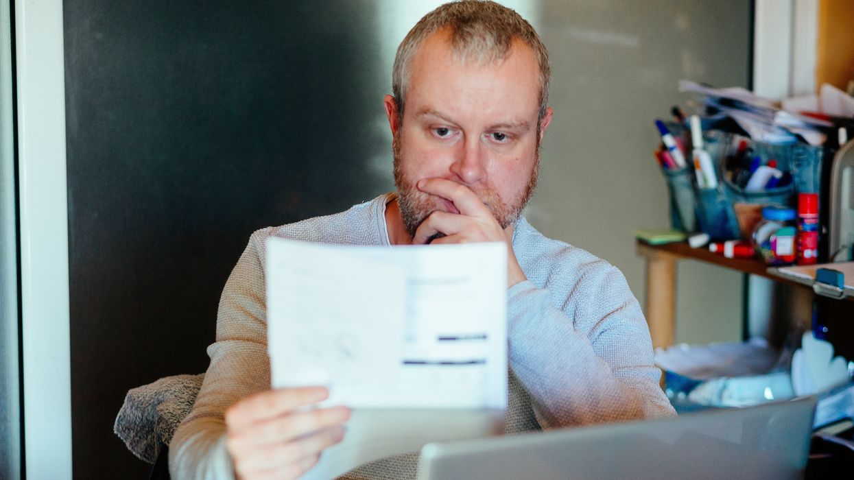 Man looks worried at bank statement