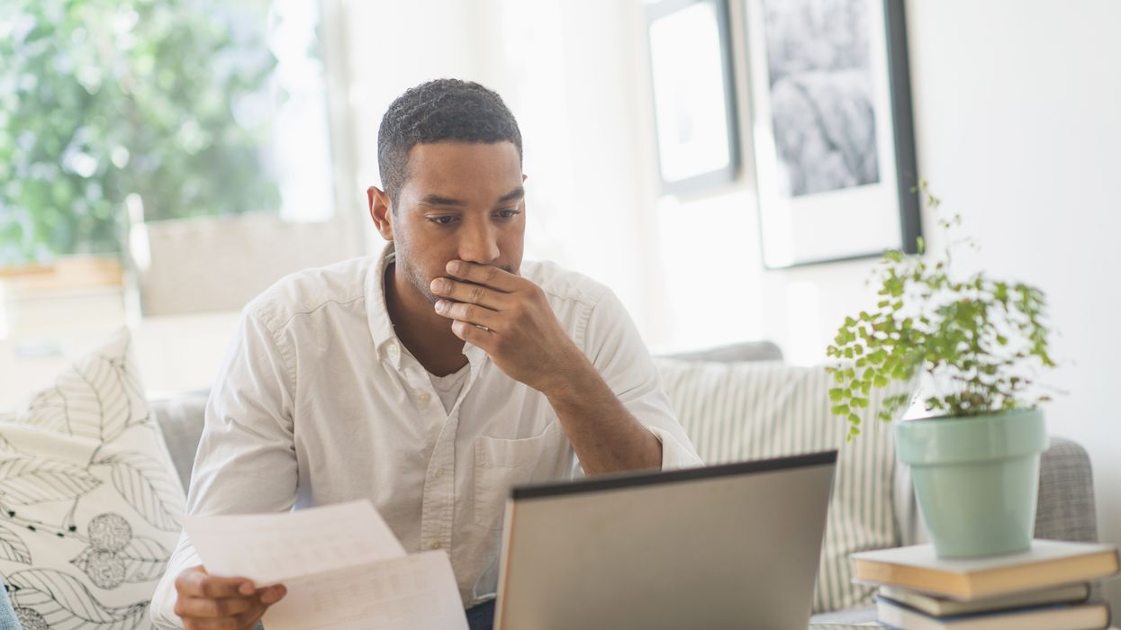 Man looks worried at laptop