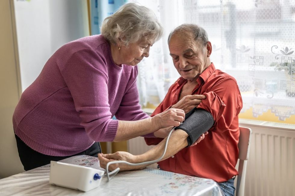 MAN MEASURING BLOOD PRESSURE