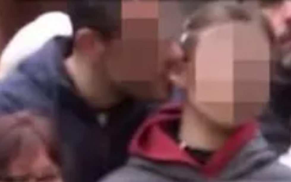 Man nibbling child's ear