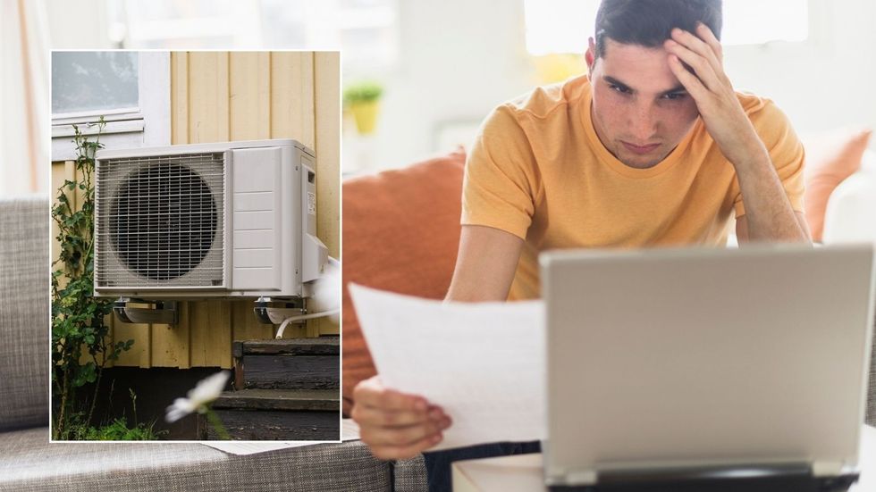 Man on laptop and heat pump