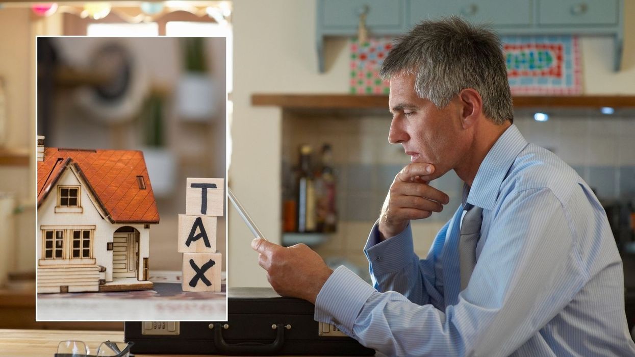 Man on laptop and tax sign