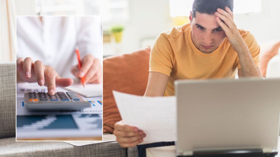Man on laptop going over finances and calculator