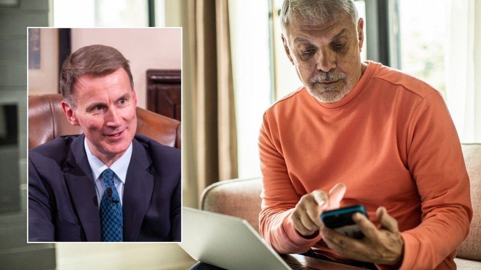 Man on phone and Jeremy Hunt at event