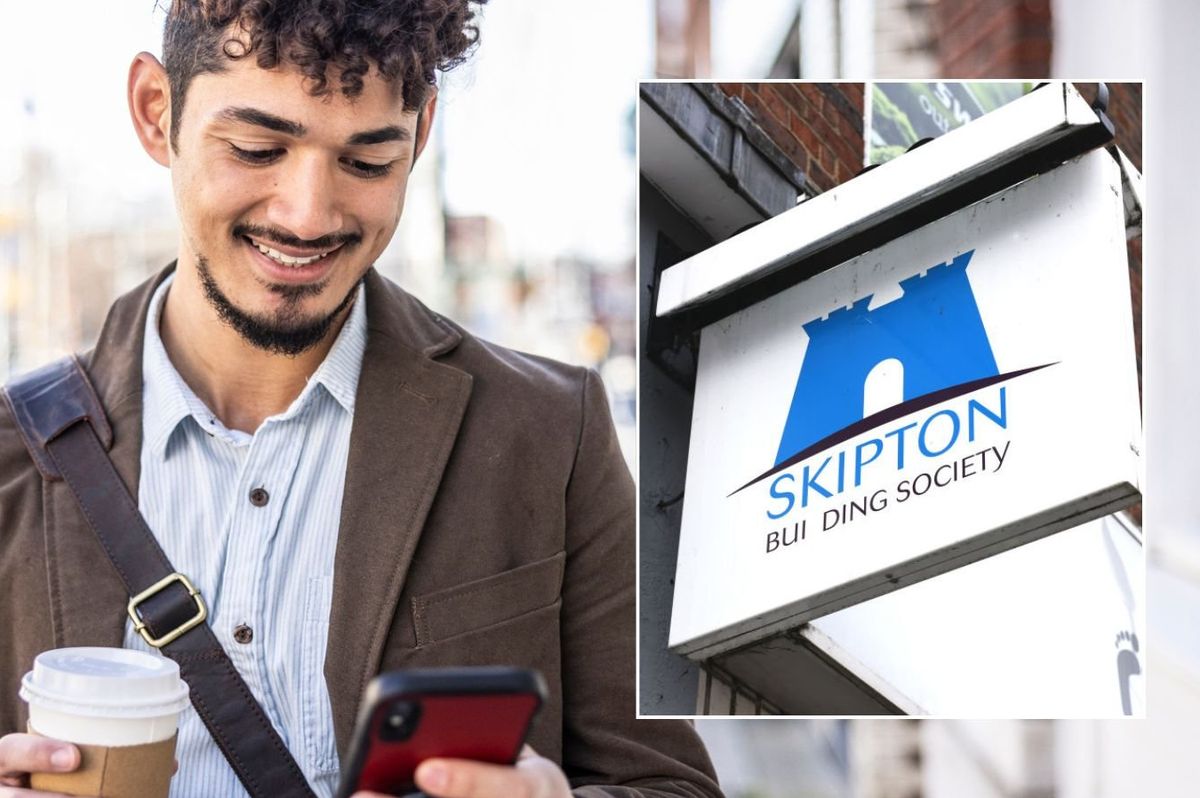 Man on phone and Skipton Building Society sign