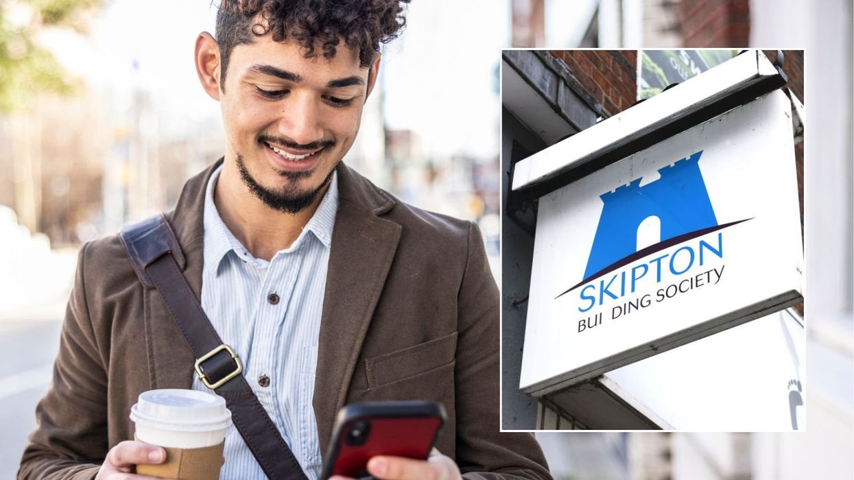 Man on phone and Skipton Building Society sign