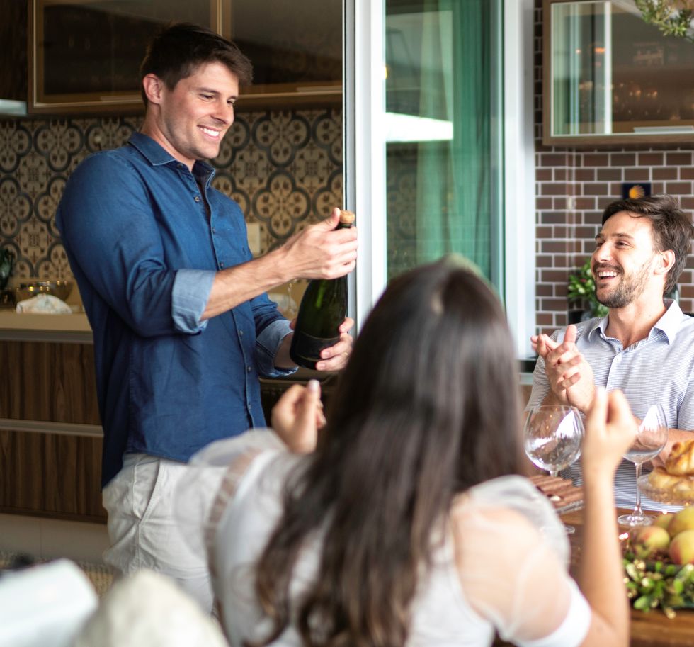 Man opening prosecco