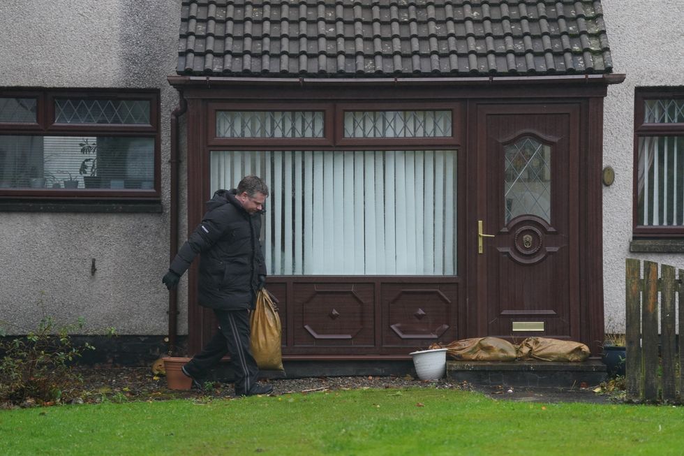 Man places sandbags in front of his front door