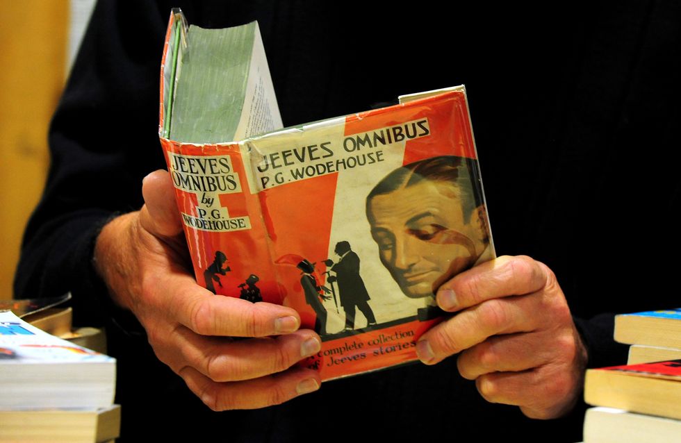 Man reading a first edition of Jeeves Omnibus