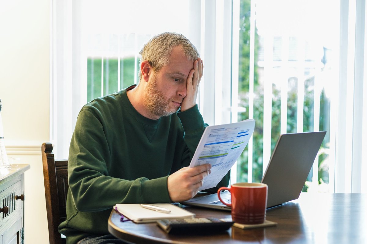 Man reading energy bills