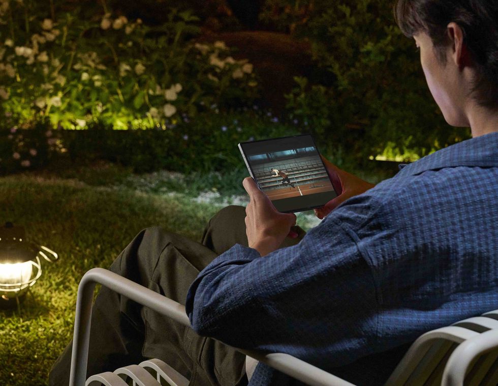 man sat on a garden chair watching a film on the galaxy z fold 6