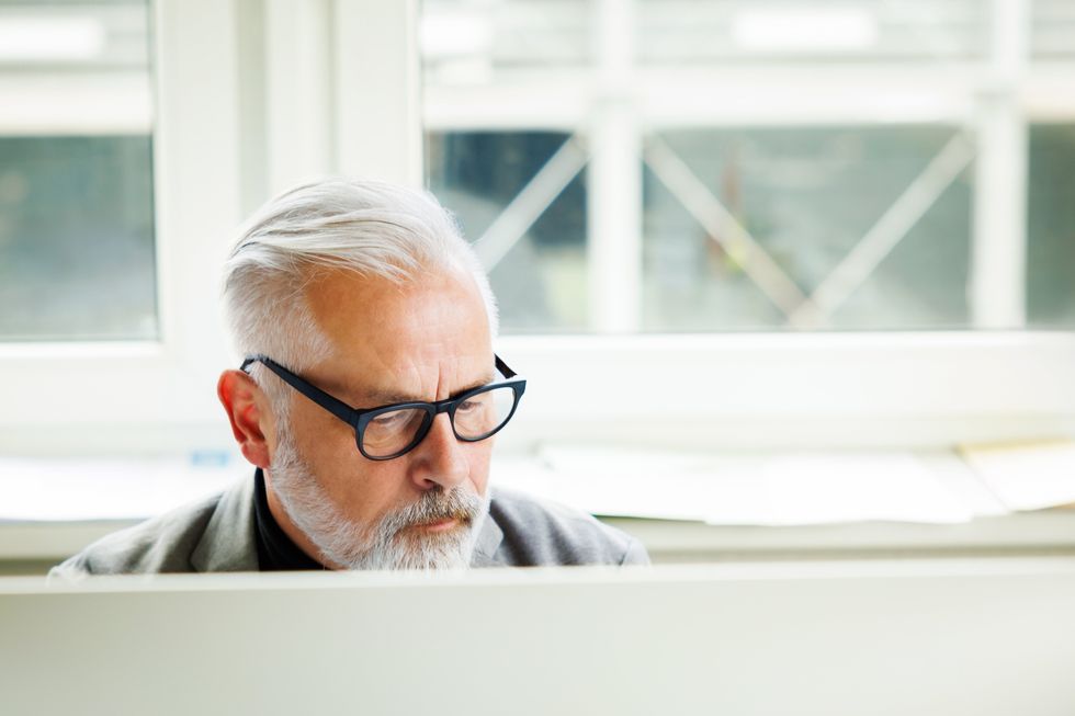 MAN SITTING AT DESK