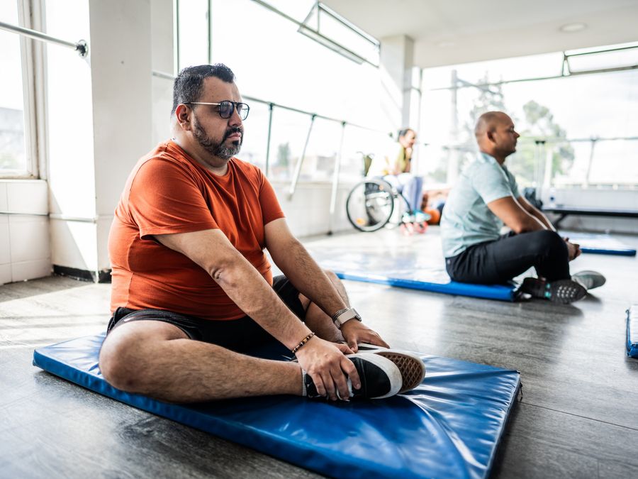 Man stetching in yoga class
