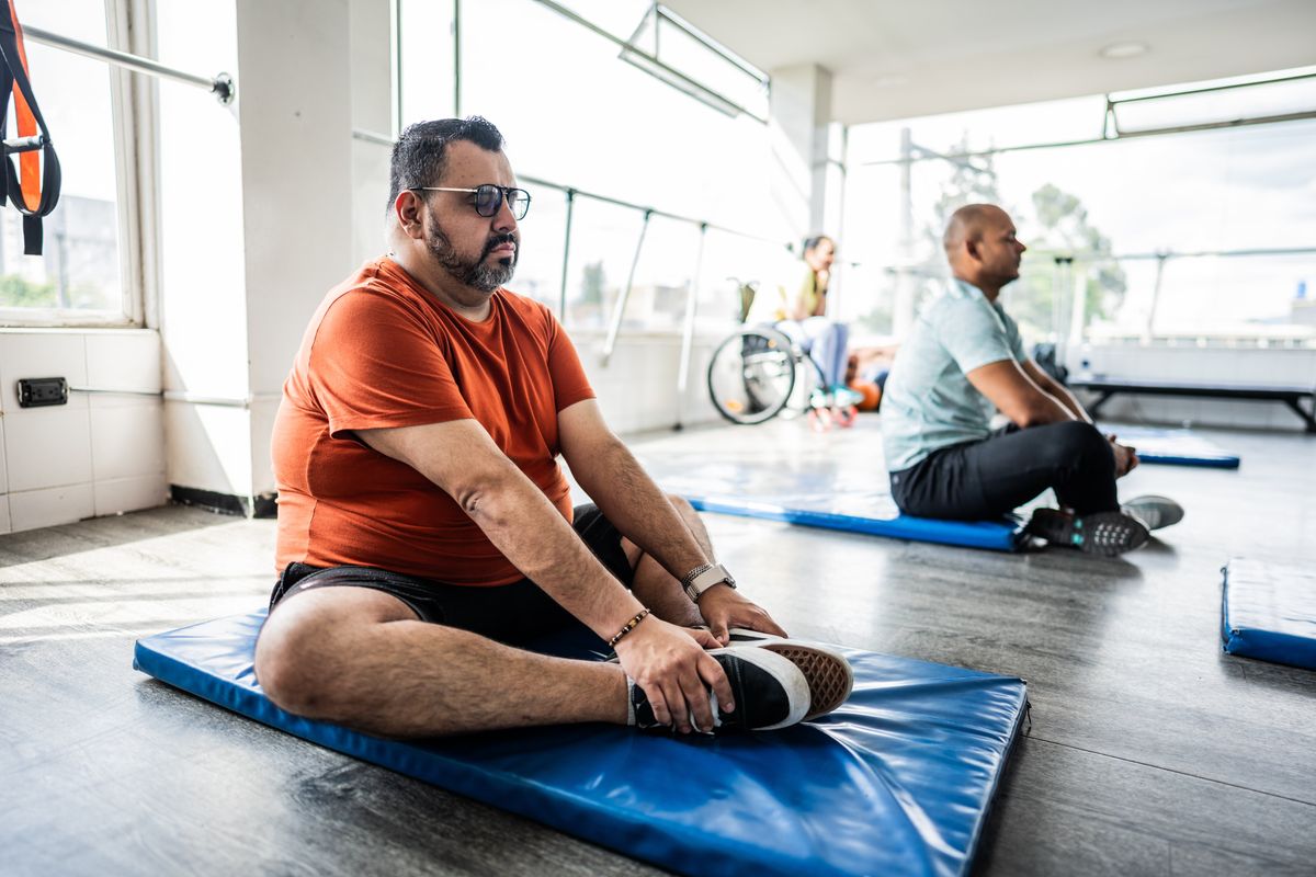 Man stetching in yoga class