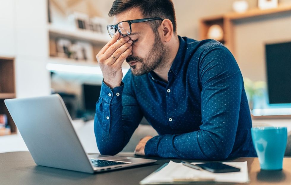 Man stressed at laptop