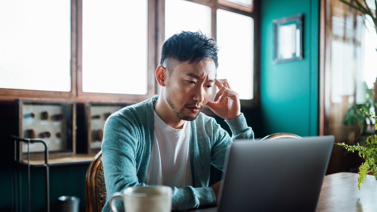 Man stressed at laptop