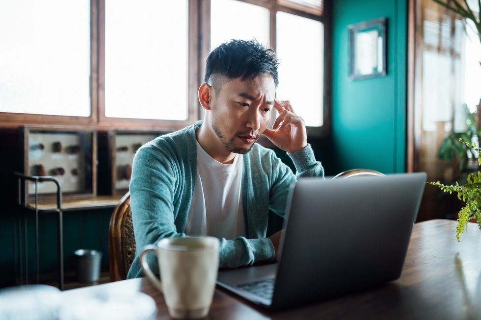 Man stressed at laptop
