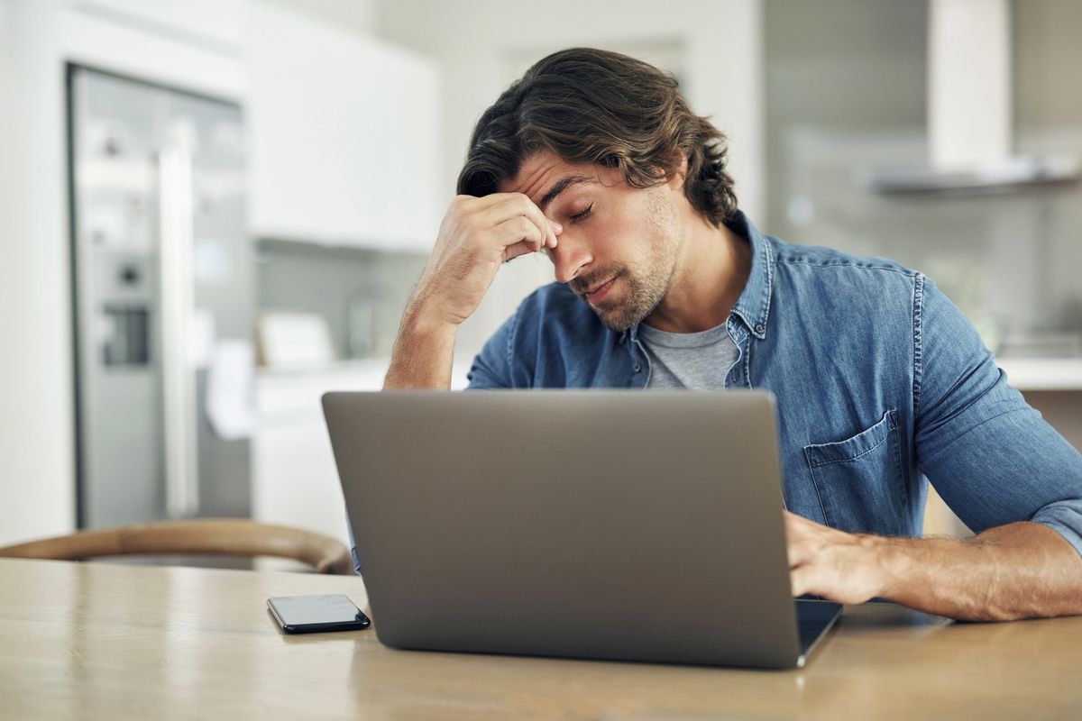Man stressed at laptop