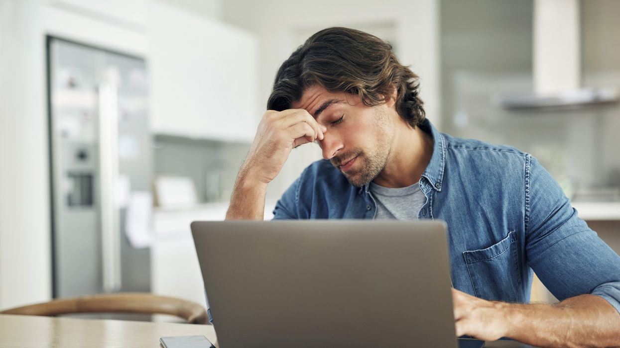 Man stressed at laptop