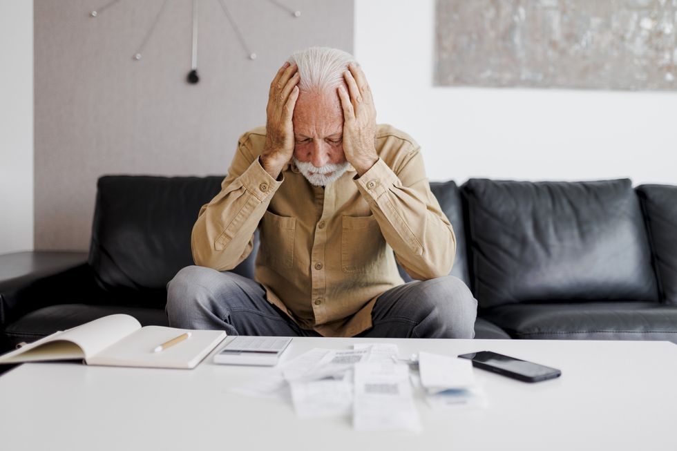 Man stressed looking at bills