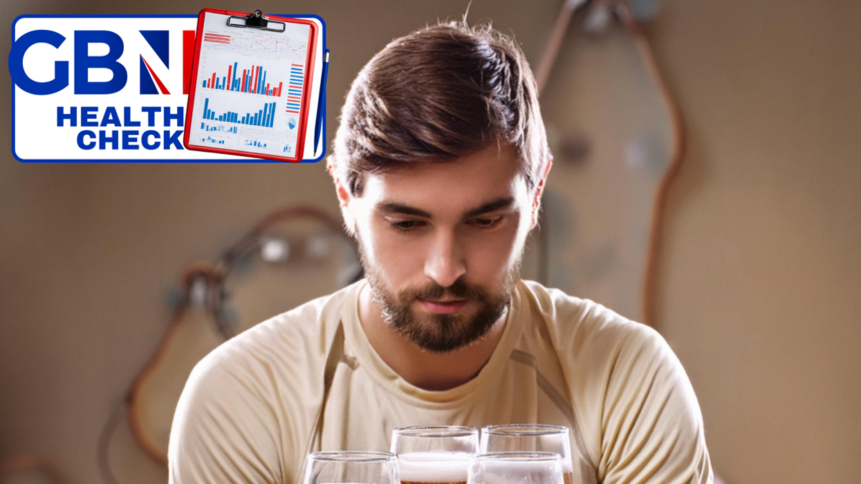 Man studying beer and dumbbells