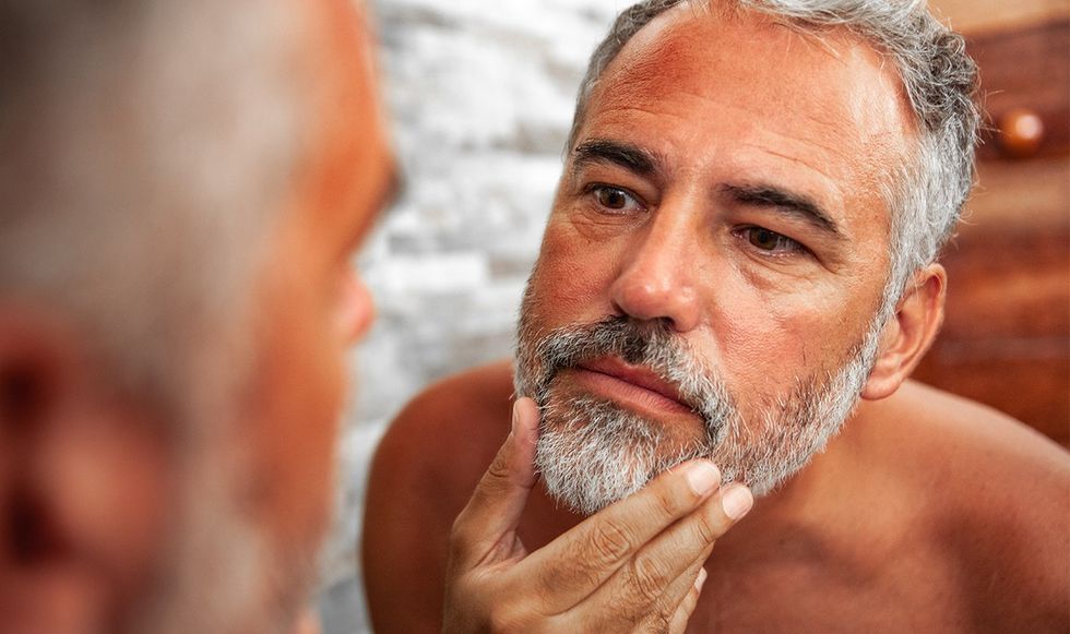 Man studying himself in the mirror