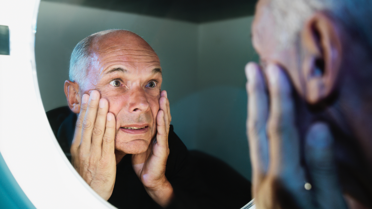 Man studying himself in the mirror