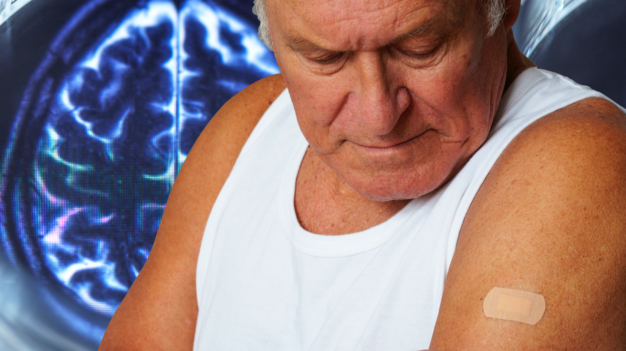 Man studying his arm in front of a brain scan