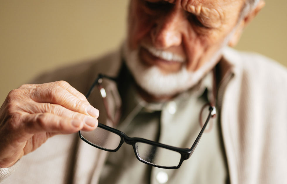 Man studying his glasses