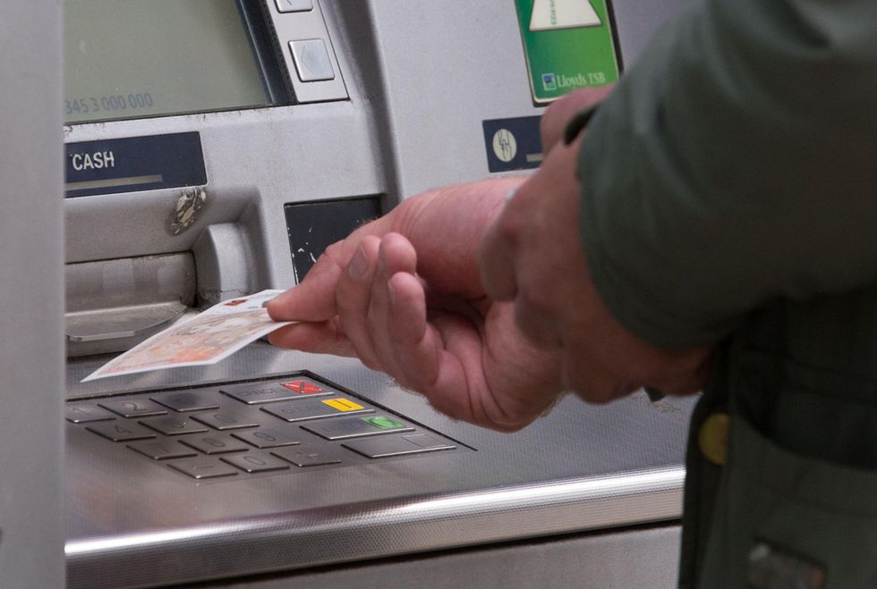 Man taking cash out of a cash point