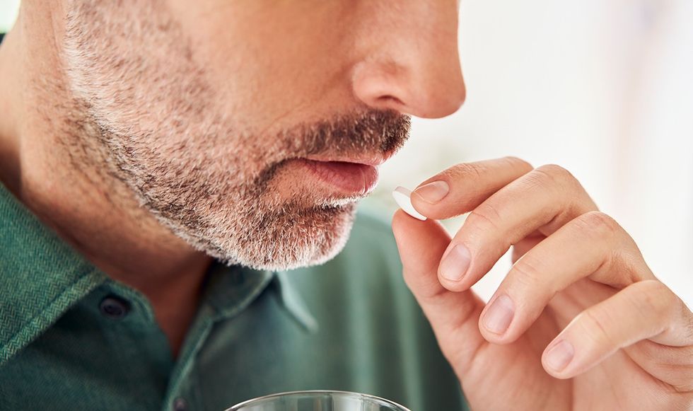 MAN TAKING PILL