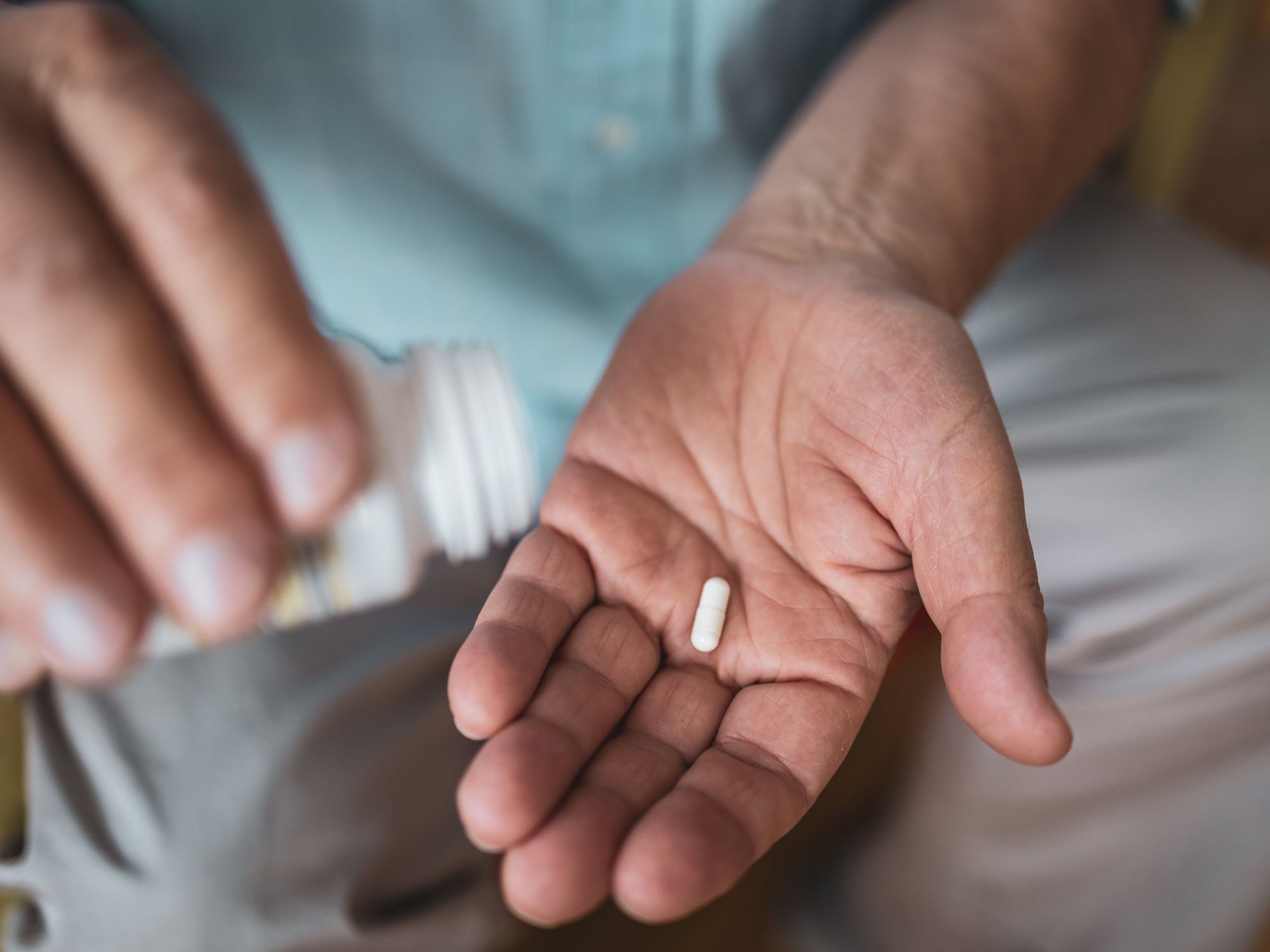 man taking white pill