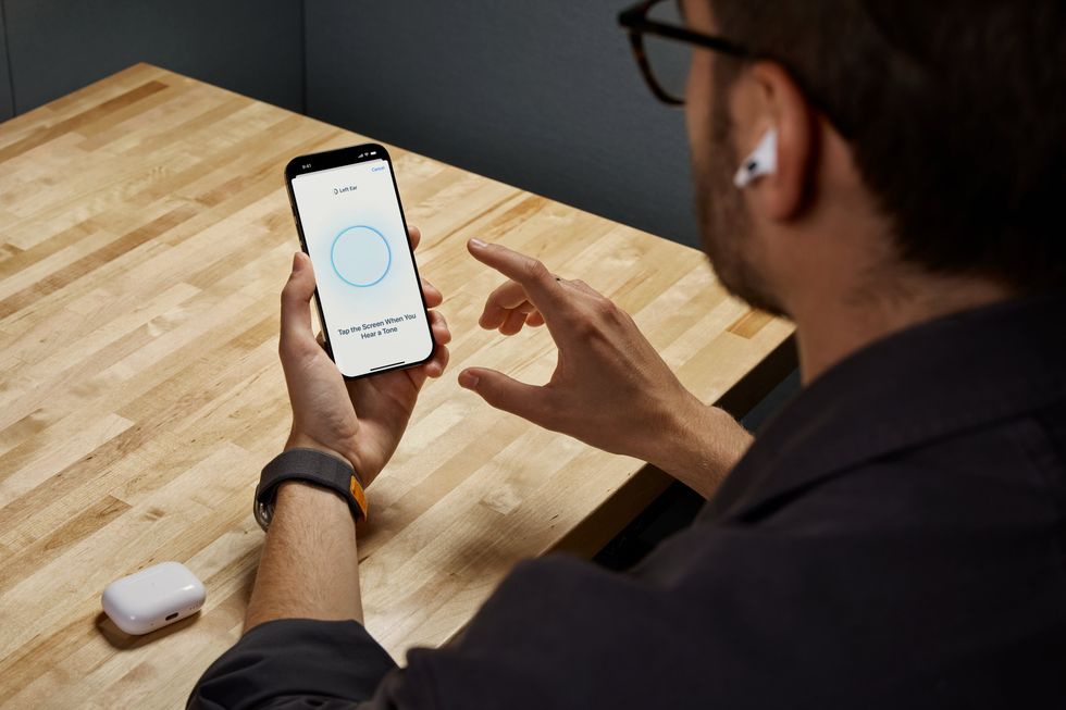 man using airpods pro 2 to test hearing