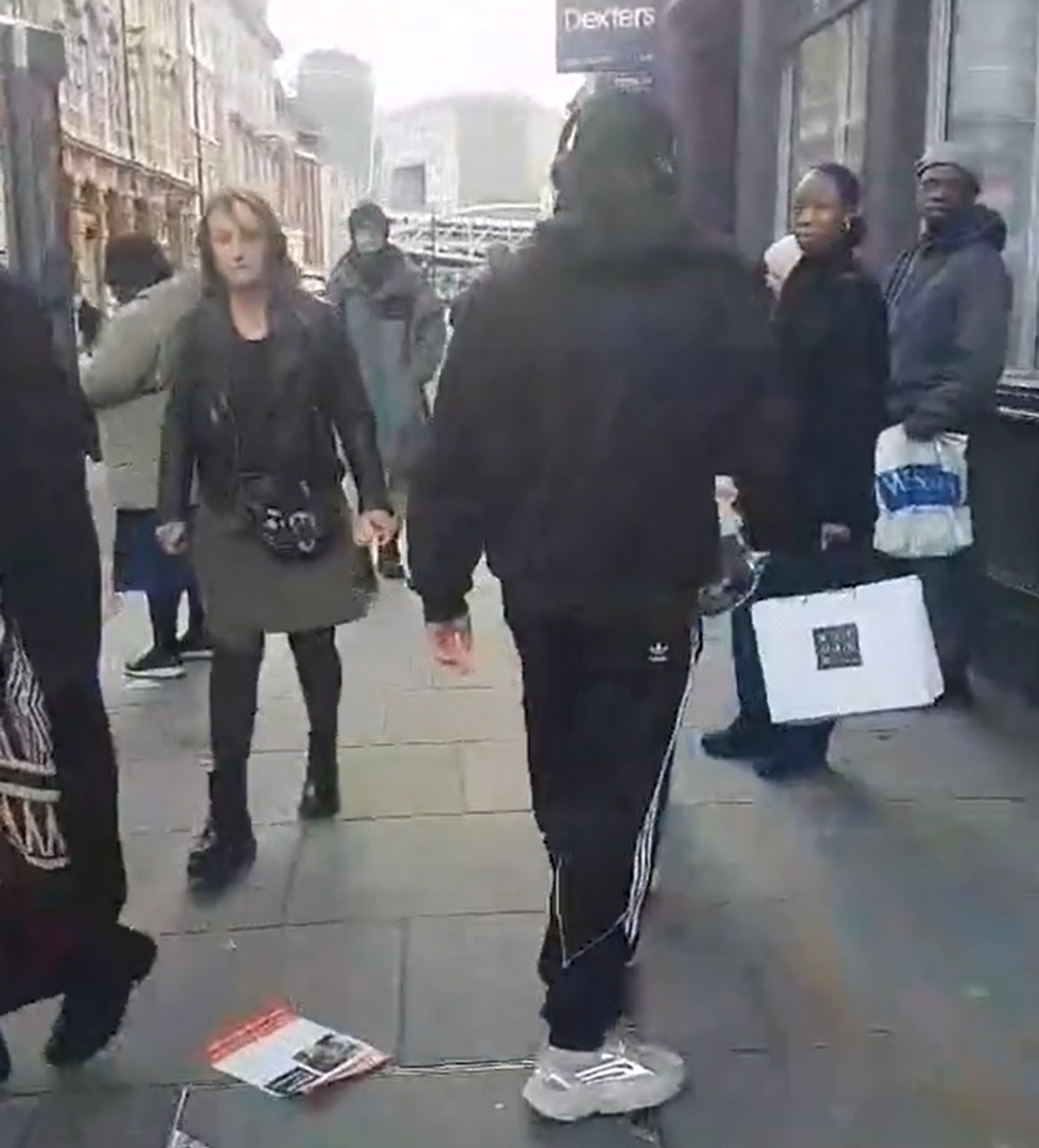 Man walking away after chucking poster on the floor