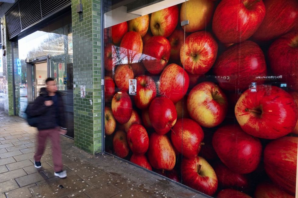 Man walking outside Co-op in London