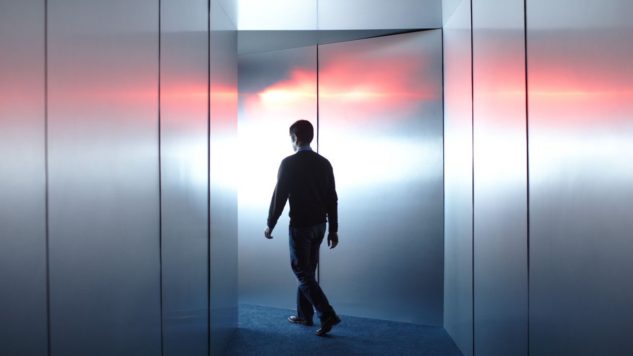 Man walking towards beam of light