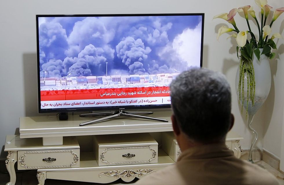 Man watches news of explosion