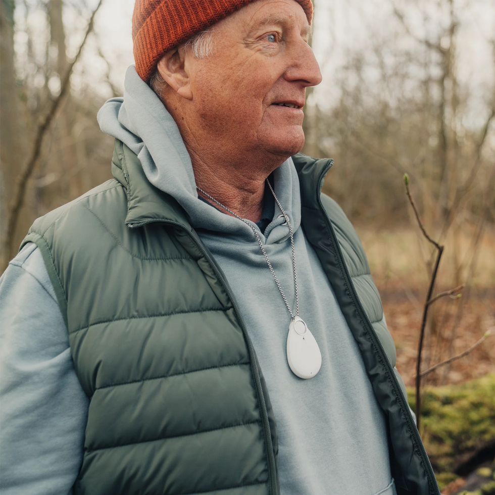 Man wearing personal alarm device