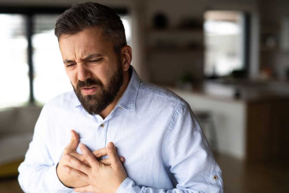 MAN WITH HAND IN CHEST