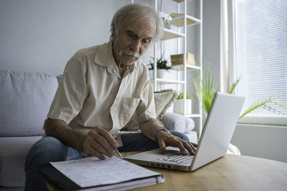 Man working while using laptop