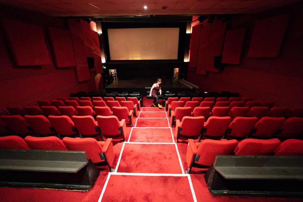 Manager Katie Markwick prepares screen 1 ahead of the reopening of The Electric Cinema in Birmingham, which was forced to close permanently during the pandemic but is back in use after it was rescued by new owner Kevin Markwick. The 112-year-old art deco cinema, built in a converted taxi rank, began operating in December 1909 and is believed to be the oldest working cinema in the UK. Picture date: Tuesday January 18, 2022.
