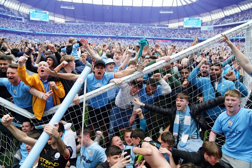 Manchester City fans invade the pitch after their side won the Premier League following a 3-2 victory over Aston Villa at The Etihad Stadium, Manchester.