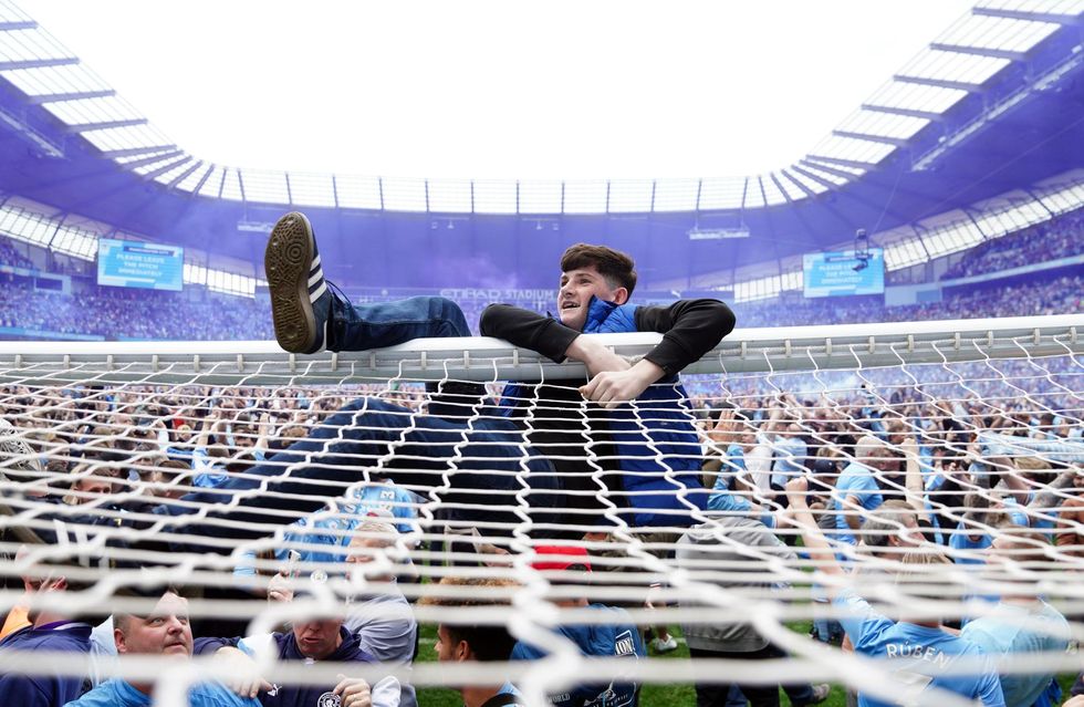 Manchester City fans invade the pitch after their side won the Premier League following a 3-2 victory over Aston Villa at The Etihad Stadium, Manchester.