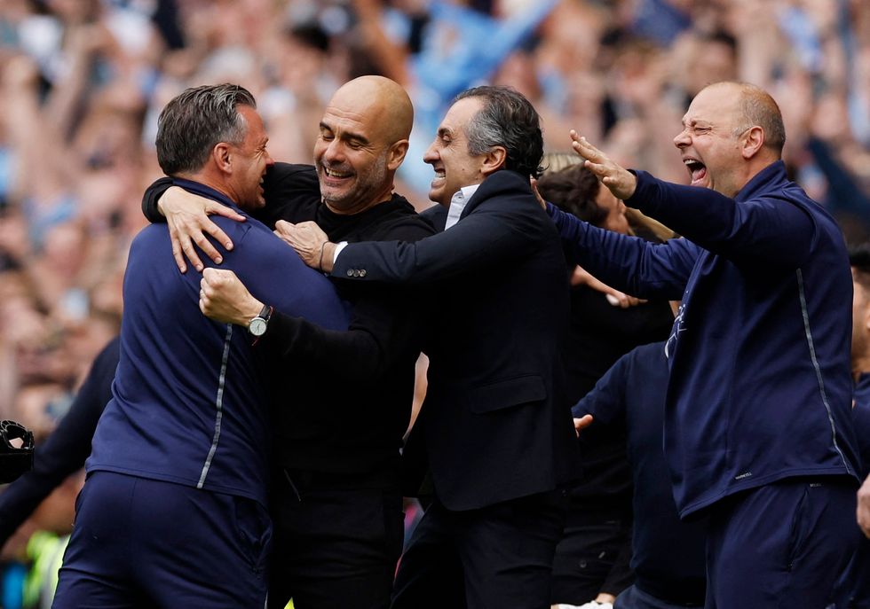 Manchester City manager Pep Guardiola celebrates after winning the Premier League