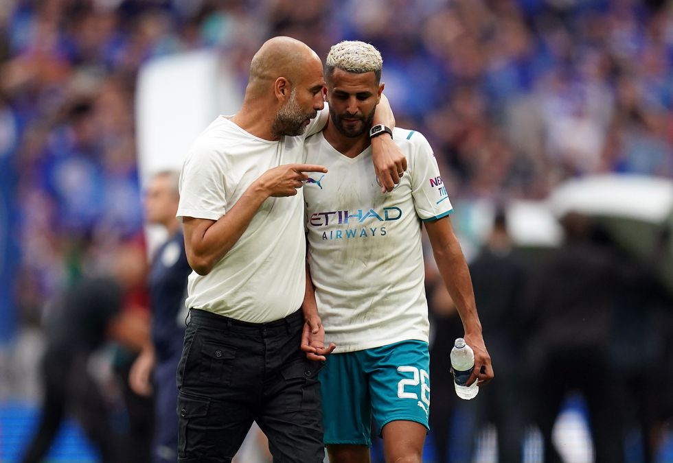 Manchester City manager Pep Guardiola with Riyad Mahrez