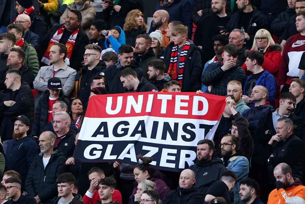 Manchester United fans in the stands hold up a banner reading %22United Against Glazer%22 during the Premier League match at Old Trafford, Manchester. Picture date: Saturday April 2, 2022.